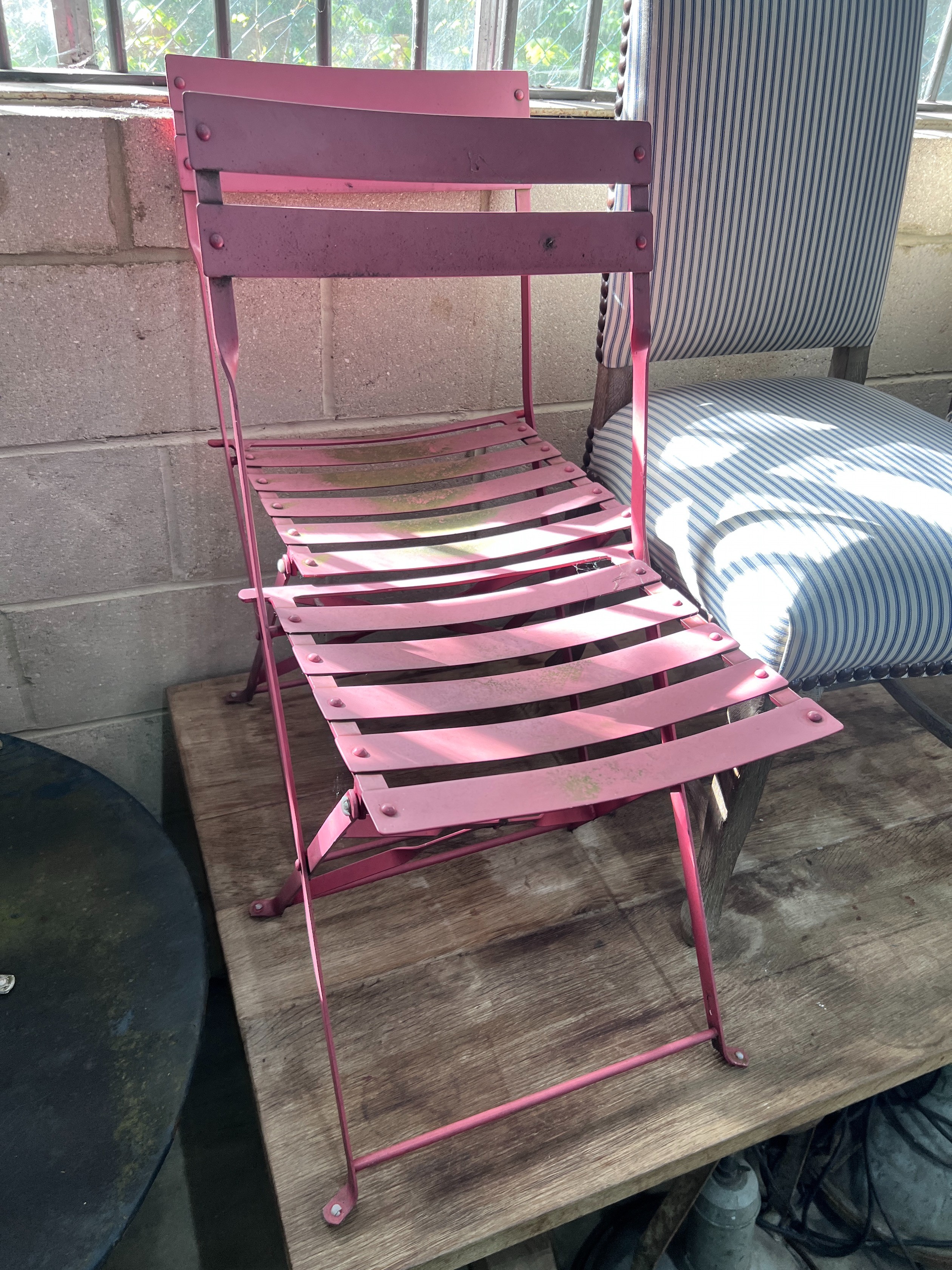 A circular metal and wrought iron garden table, diameter 90cm and three chairs *Please note the sale commences at 9am.